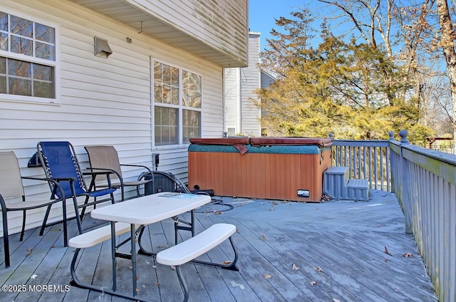 wooden terrace featuring a hot tub