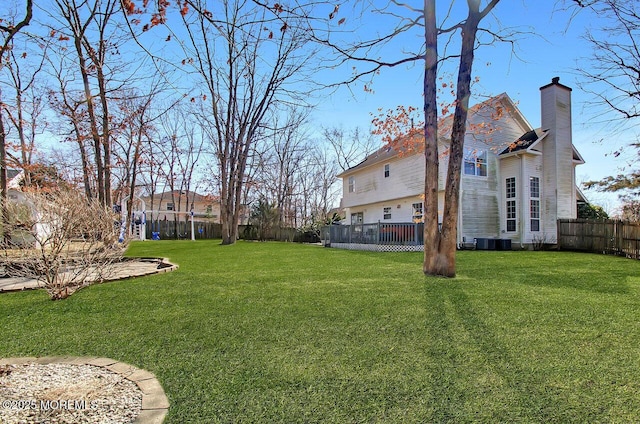 view of yard featuring a fenced backyard and central AC