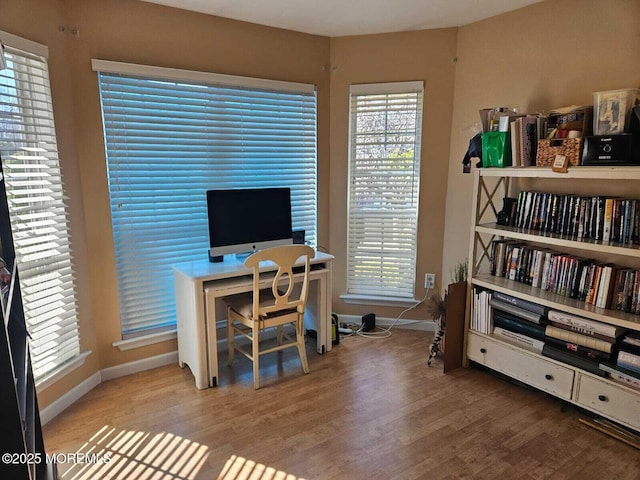 office space featuring baseboards and wood finished floors