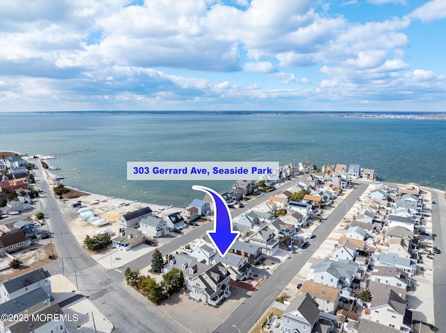 bird's eye view with a water view and a residential view