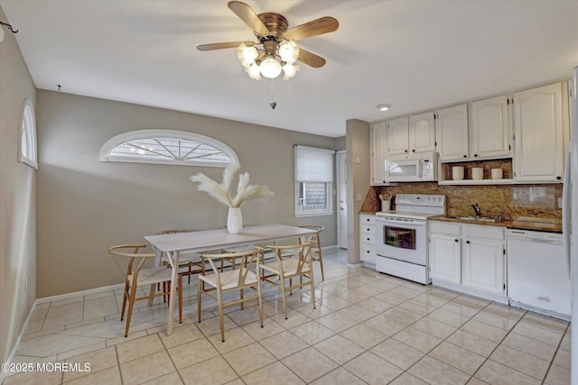 kitchen featuring light tile patterned floors, white appliances, white cabinets, and tasteful backsplash