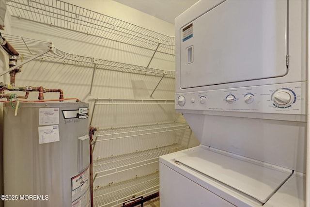 laundry room with laundry area, stacked washer and clothes dryer, and water heater