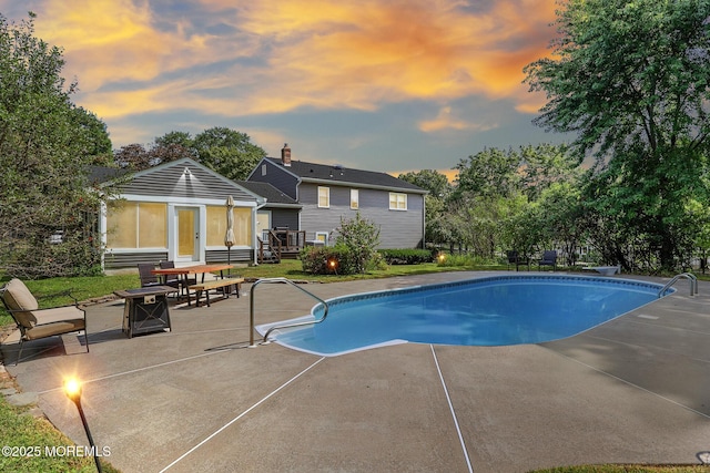 pool featuring a patio area and entry steps