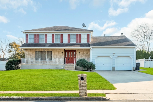 view of front of house with an attached garage, driveway, and a front yard