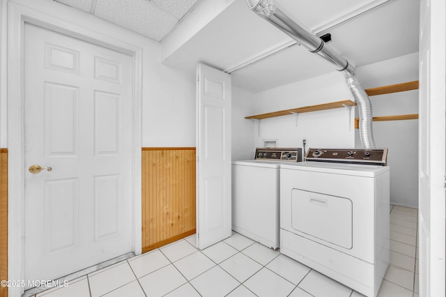 clothes washing area featuring light tile patterned floors, laundry area, and independent washer and dryer