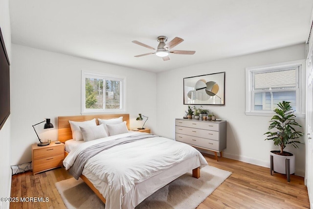 bedroom featuring light wood-style floors, baseboards, and ceiling fan