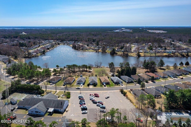 drone / aerial view featuring a water view and a residential view