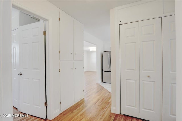 corridor featuring light wood-style flooring