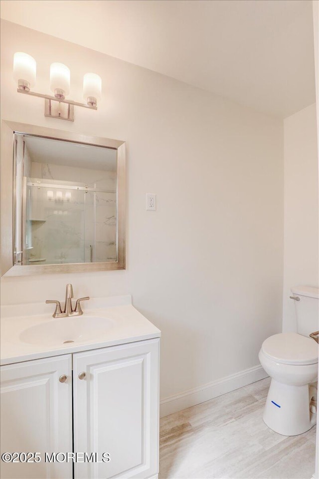 16 Mount Kisco Dr, Toms River, NJ 08753 - bathroom featuring baseboards, toilet, vanity, an enclosed shower, and wood finished floors