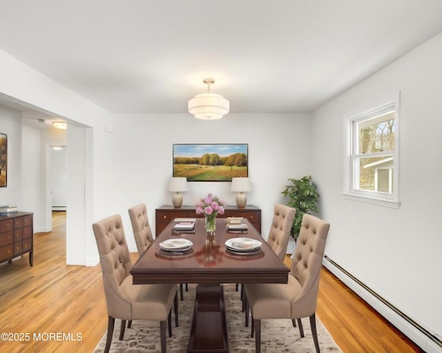 16 Mount Kisco Dr, Toms River, NJ 08753 - dining area with a baseboard heating unit, light wood-style flooring, and baseboards