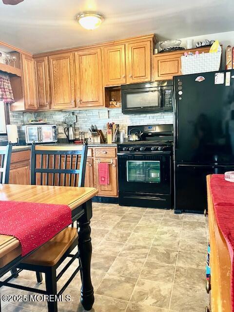 kitchen featuring black appliances, tasteful backsplash, and open shelves