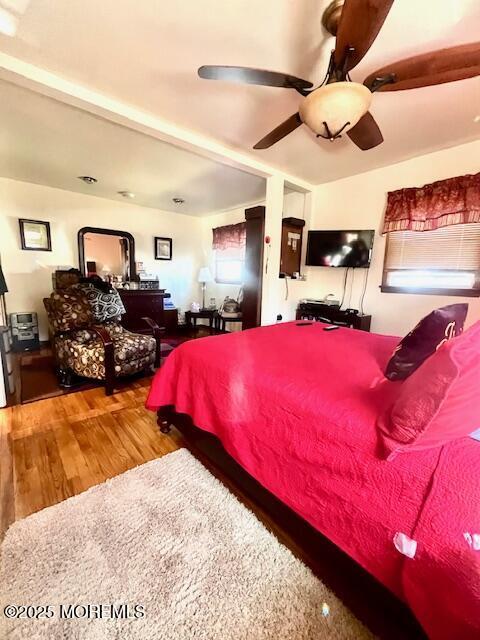 bedroom featuring ceiling fan and wood finished floors