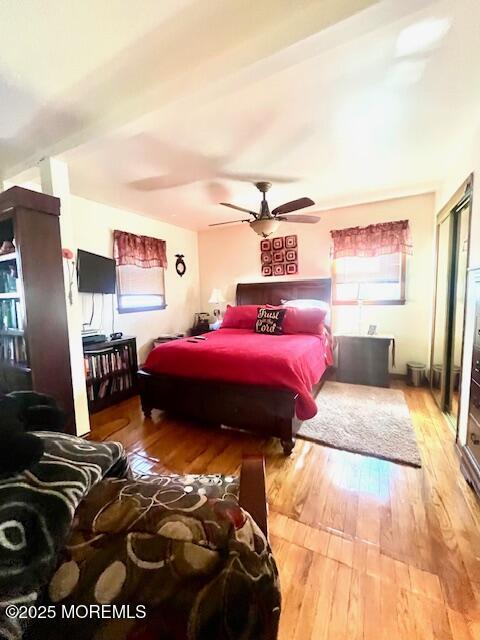 bedroom featuring wood-type flooring and a ceiling fan