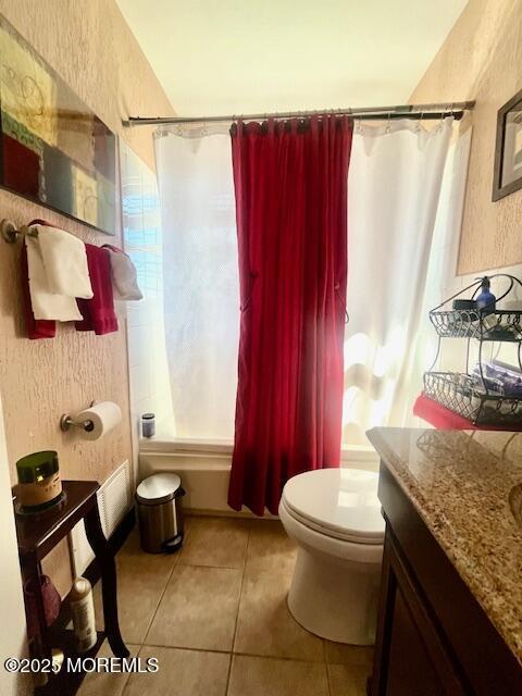 full bathroom featuring toilet, tile patterned flooring, shower / bathtub combination with curtain, and vanity