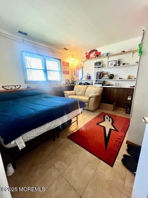 bedroom with light tile patterned flooring and visible vents