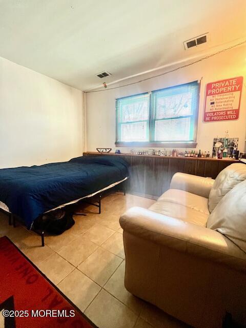 bedroom featuring light tile patterned floors and visible vents