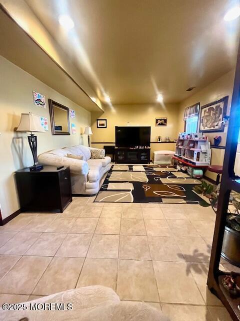 tiled living area featuring baseboards