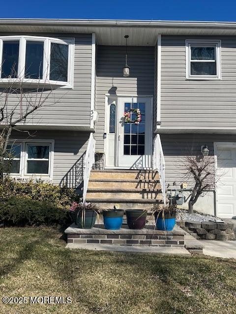 exterior space with a garage and entry steps