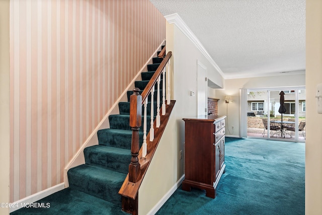 staircase featuring carpet, crown molding, a textured ceiling, and baseboards