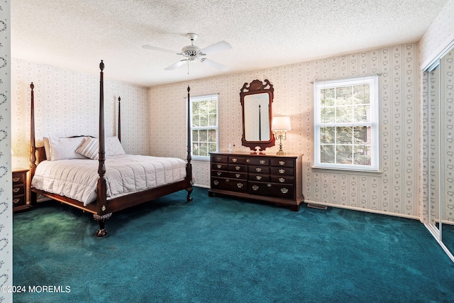 bedroom with carpet flooring, ceiling fan, a textured ceiling, baseboards, and wallpapered walls