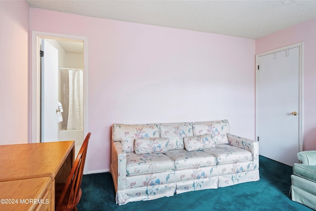 living area featuring carpet floors and a textured ceiling