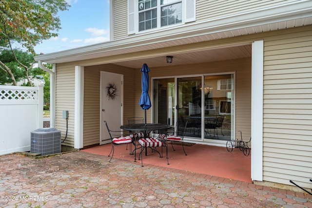 view of patio / terrace featuring cooling unit and fence