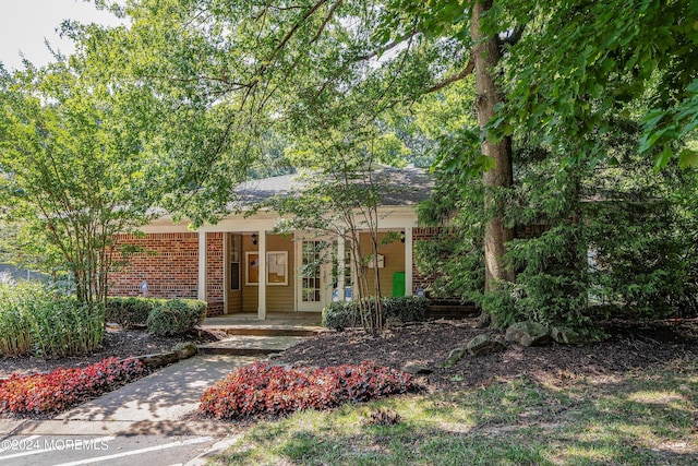 view of front of property featuring a porch and brick siding