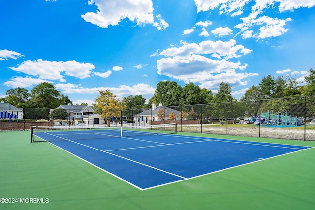 view of tennis court featuring fence