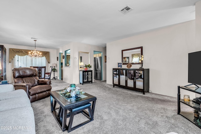 carpeted living area with a chandelier and visible vents