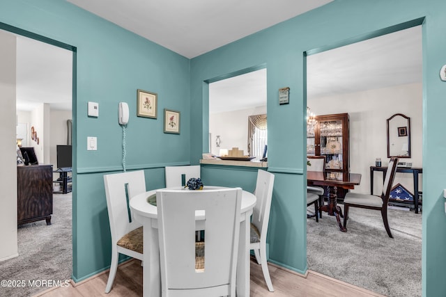 dining area with wood finished floors and carpet flooring