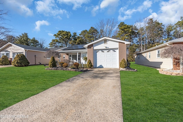 single story home featuring a garage, concrete driveway, roof mounted solar panels, a front lawn, and brick siding