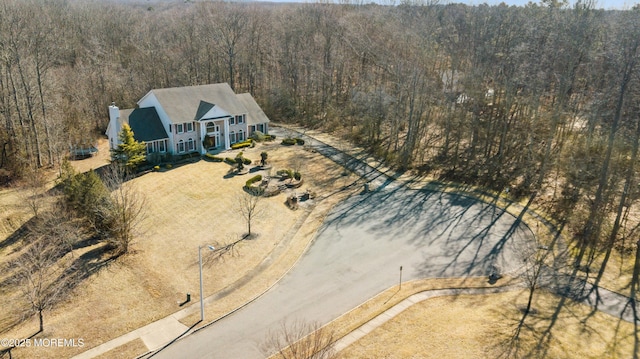 birds eye view of property featuring a view of trees