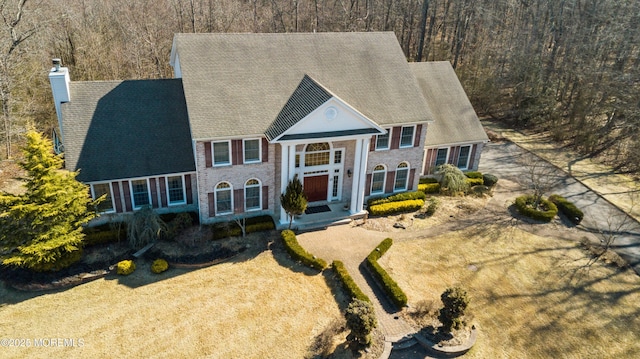 greek revival inspired property featuring a chimney