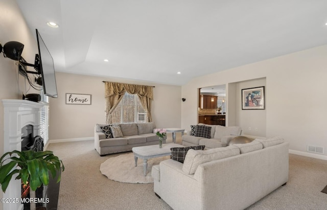 living room featuring carpet flooring, a fireplace, visible vents, and baseboards