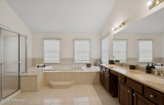 bathroom with vaulted ceiling, a sink, and a garden tub