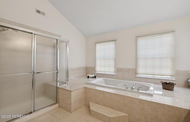 bathroom with a garden tub, visible vents, a stall shower, vaulted ceiling, and tile patterned flooring