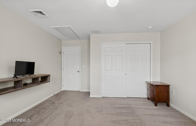 carpeted bedroom with attic access, a closet, visible vents, and baseboards