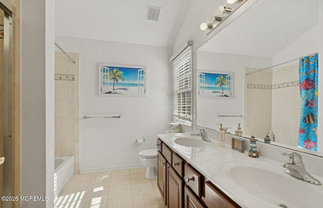 bathroom featuring toilet, visible vents, a sink, and tile patterned floors