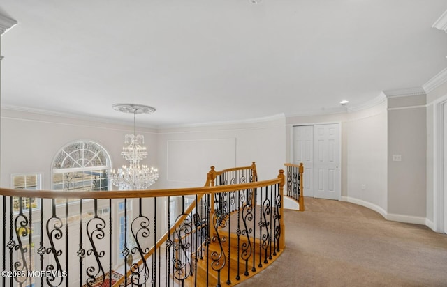 hall featuring carpet, crown molding, an inviting chandelier, an upstairs landing, and baseboards