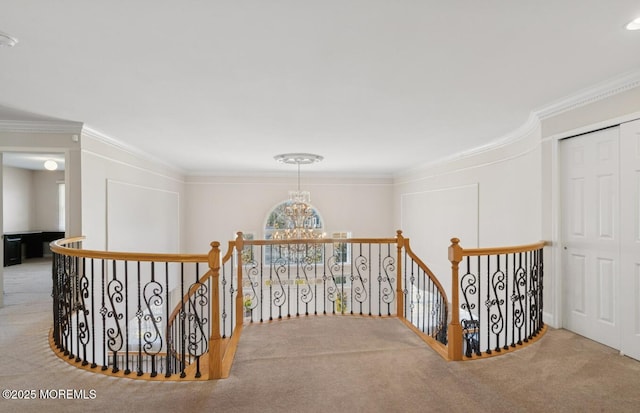 hallway with crown molding, carpet, an upstairs landing, and a notable chandelier