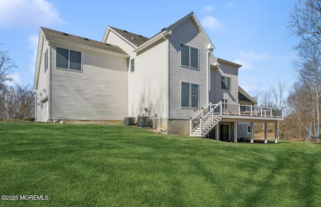 back of property featuring stairs, a deck, cooling unit, and a yard