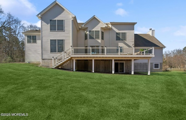 back of house with a chimney, a yard, a deck, and stairs