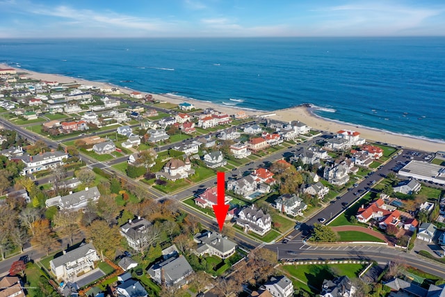 bird's eye view with a beach view, a water view, and a residential view