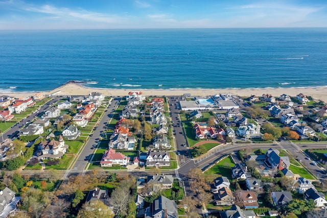 birds eye view of property with a residential view, a water view, and a beach view