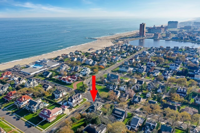 bird's eye view with a view of the beach and a water view