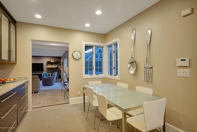 dining space with baseboards, light tile patterned flooring, light carpet, and recessed lighting