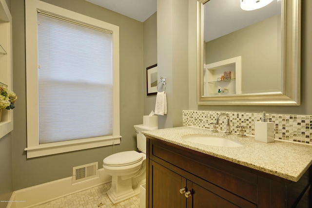 bathroom featuring toilet, tasteful backsplash, visible vents, and vanity