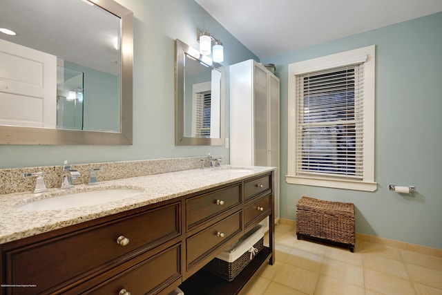 bathroom featuring a sink, baseboards, and double vanity