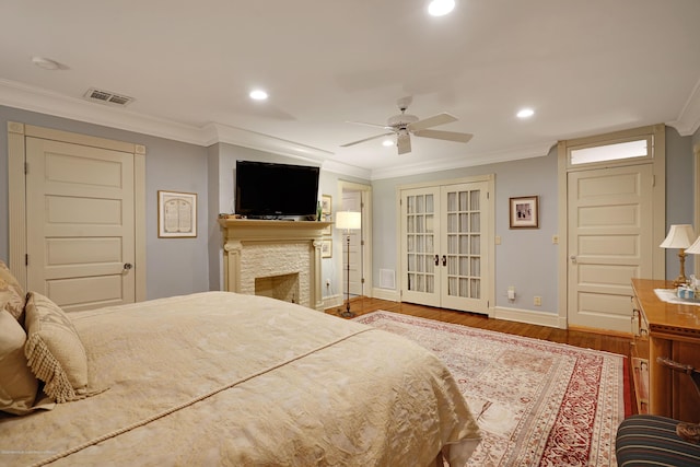 bedroom featuring recessed lighting, wood finished floors, crown molding, and french doors