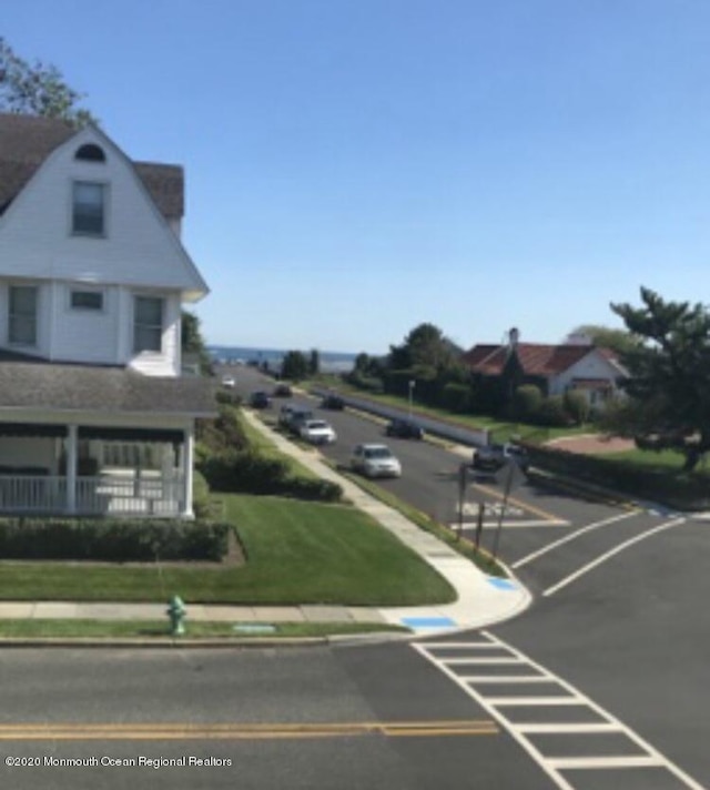 view of road with curbs and sidewalks